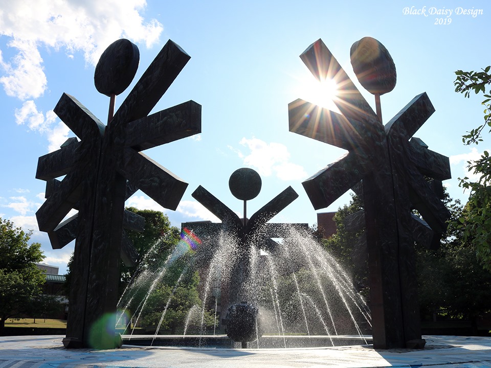 fountain with sculptures and sun