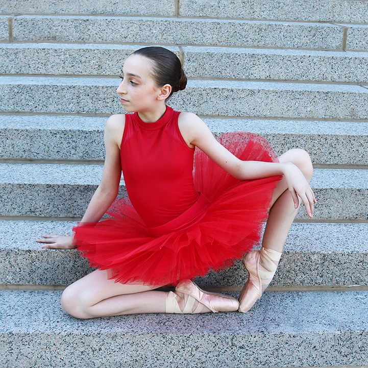 Ballerina in red on steps